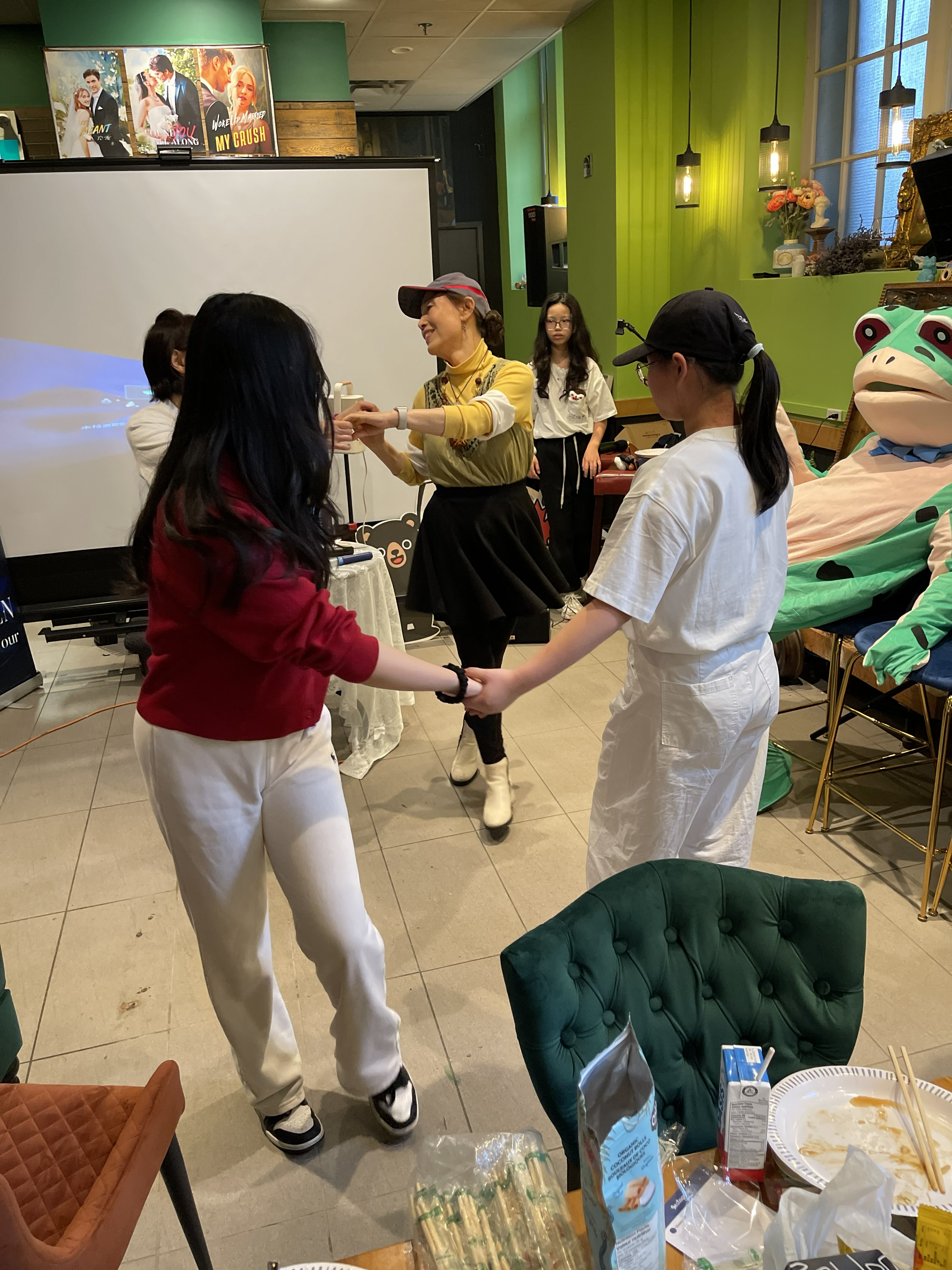 Dance activity with community members indoors.