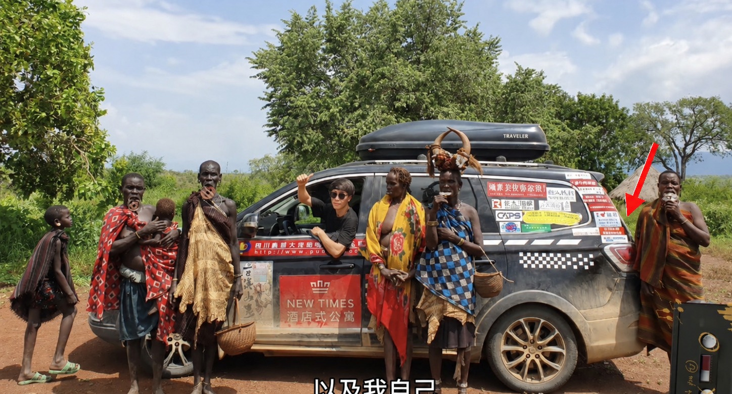 旅行车上贴着多张广告，红色箭头指向 Janet 的广告位置。