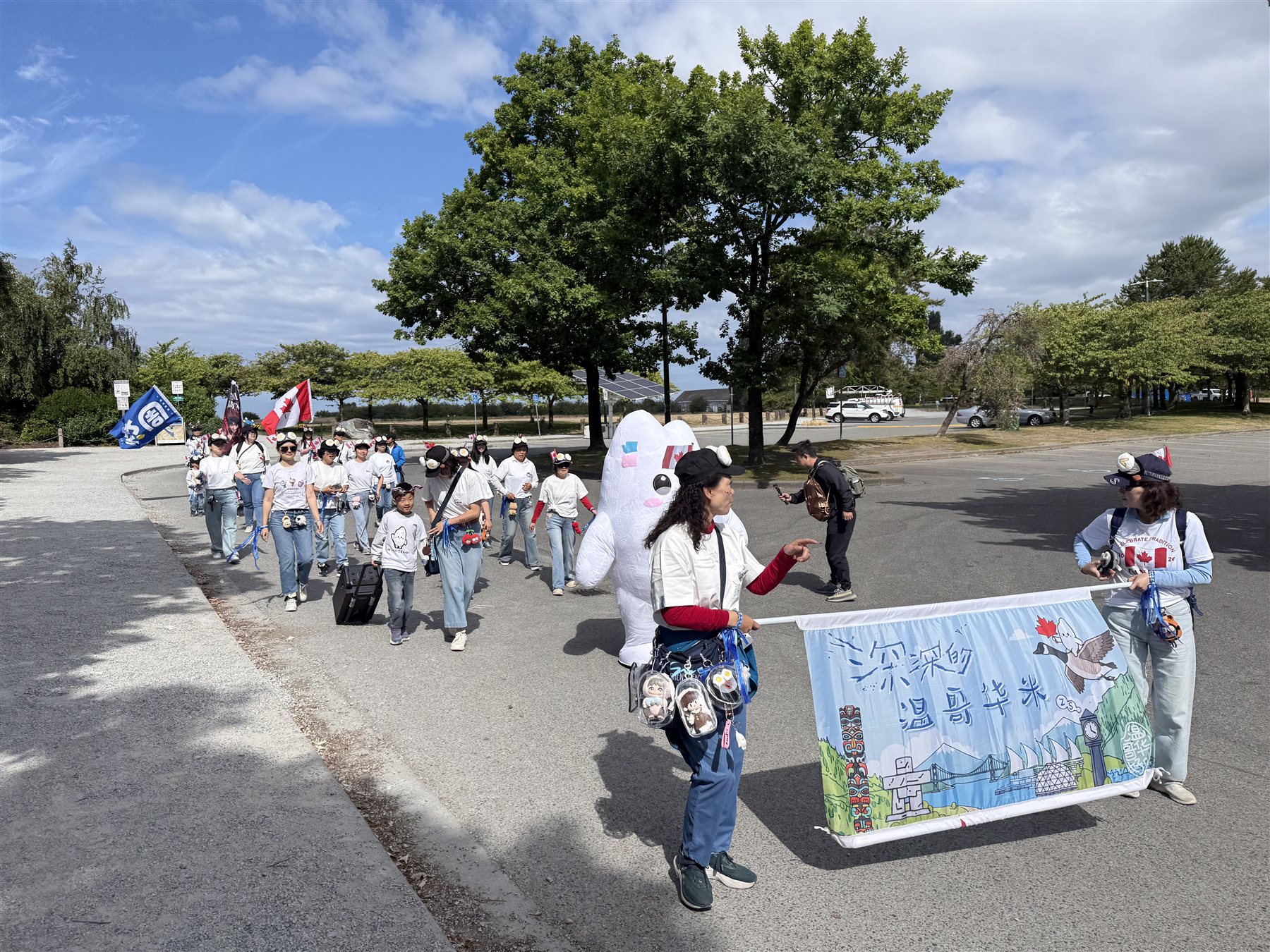 Vancouver Shengmi members entering the parade with their banner and mascot.