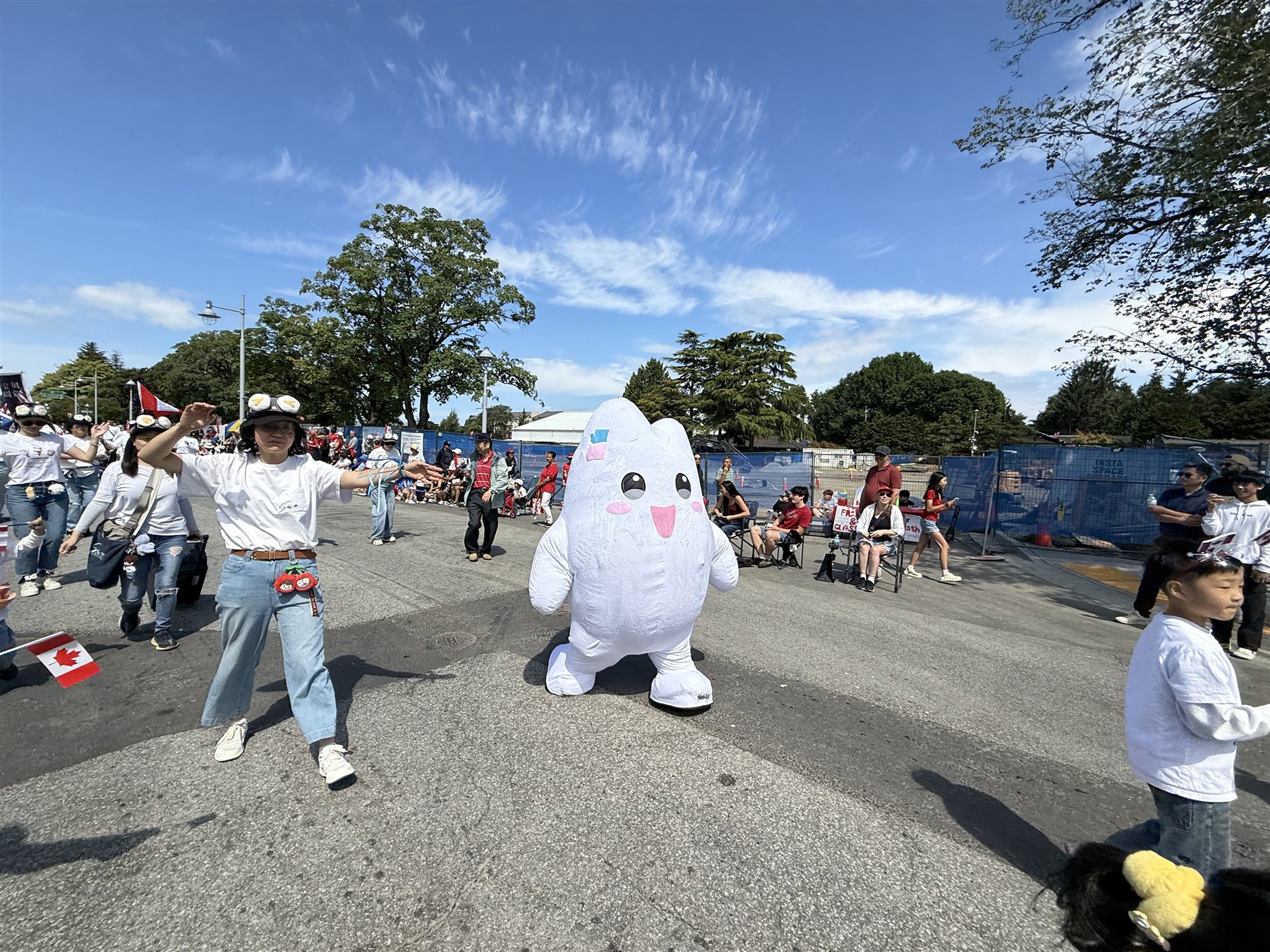 Vancouver Shengmi members dancing beside the community mascot during the parade.